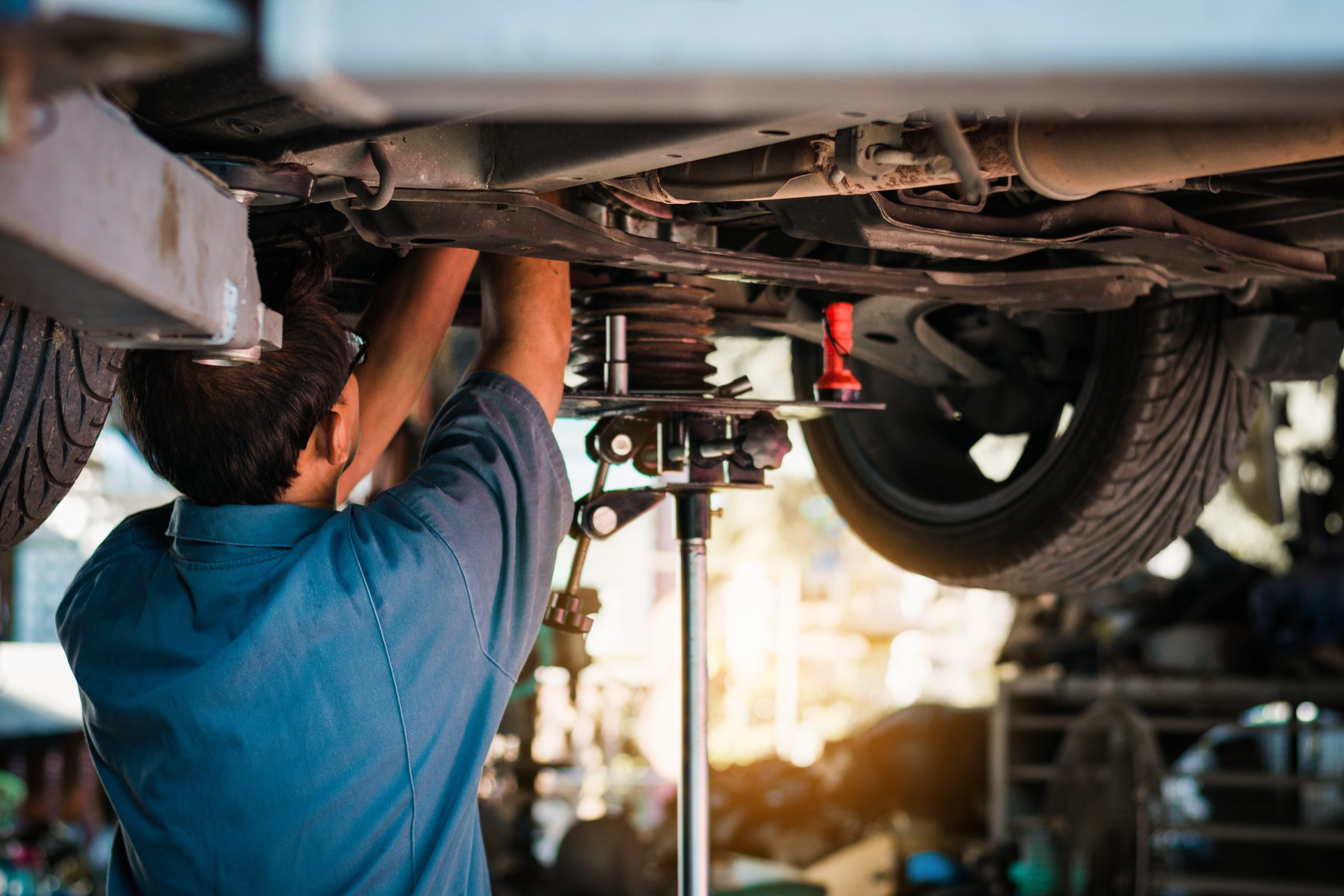 Mechanic working on the underside of a car