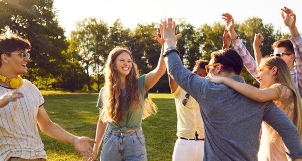 Group of people high fiving and smiling